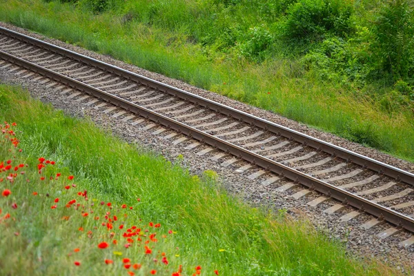 closeup railroad among green fields, industry transportation background