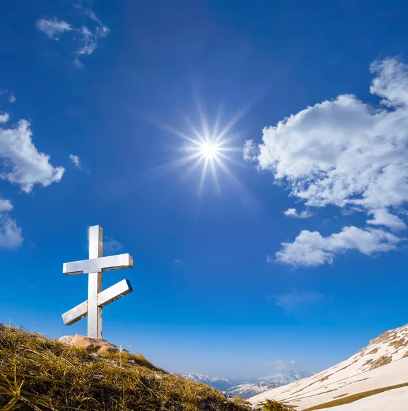 christian cross stay on mountain pass under sparkle sun, concept religious scene