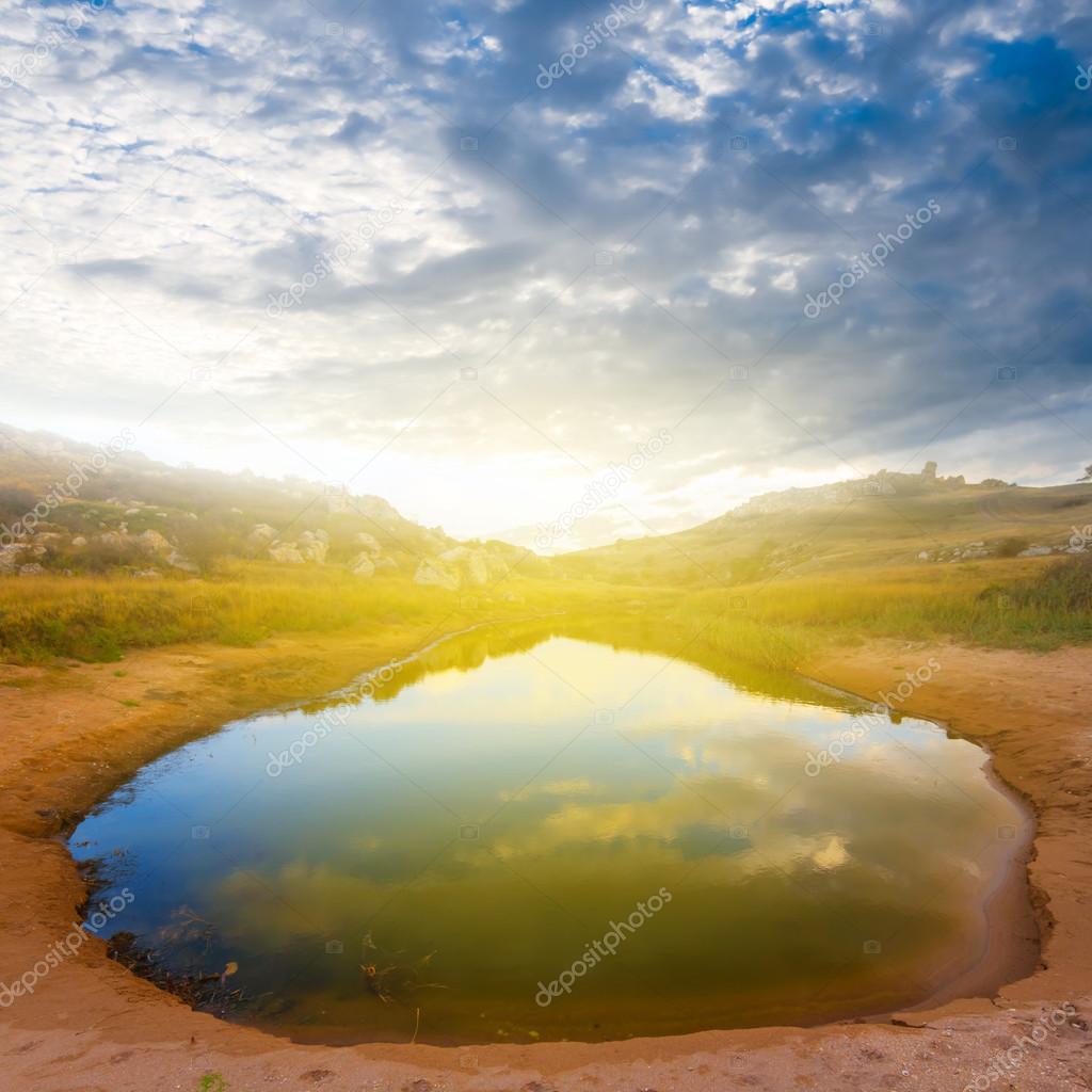 Small desert lake at the sunset