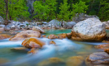 Zümrüt dağ nehri kocaman taşların arasında akıyor.