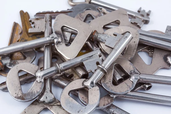 Heap of steel keys on a white background — Stock Photo, Image
