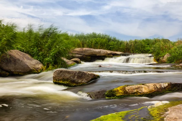 River rushing through a stony field — Stock Photo, Image