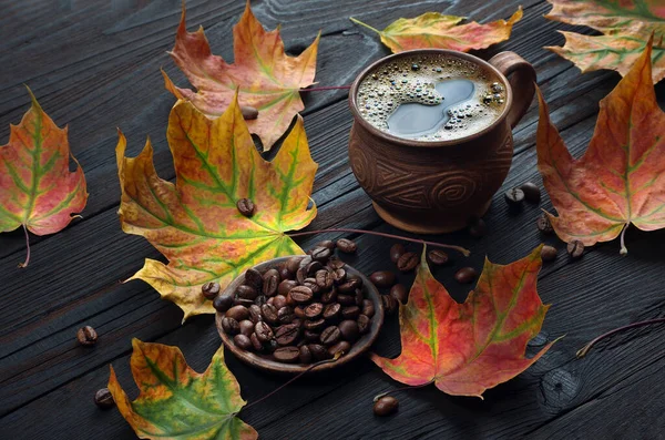 autumn coffee. dry colorful maple leaves and a cup of coffee. autumn mood