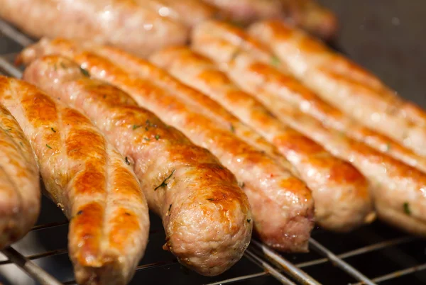 Grilling sausages on barbecue grill — Stock Photo, Image