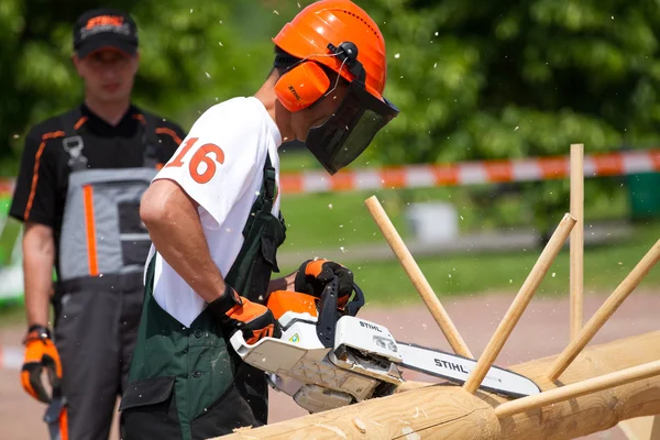 Man with chainsaw Stihl a protective mask — Stock Photo, Image