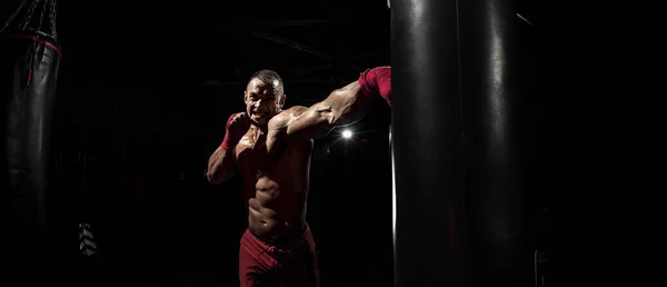 Thai Boxer Punch Kick Punching Bag Black Bacground Horizontal Photo — Stock Photo, Image