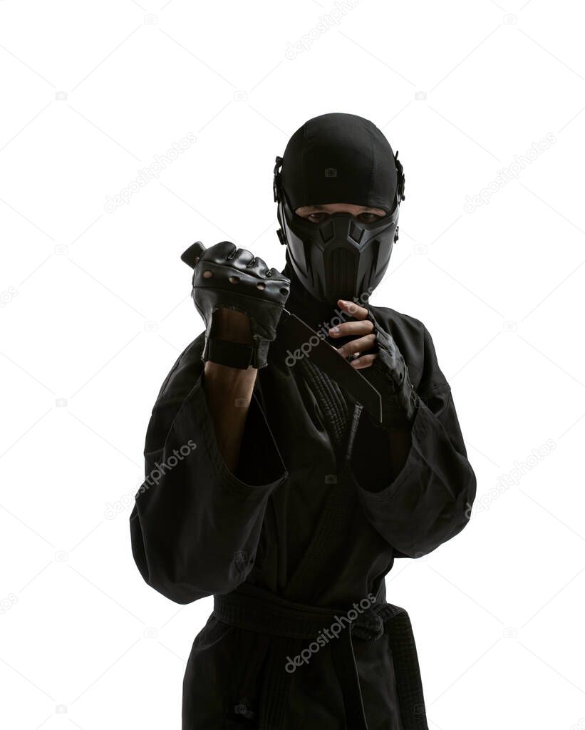 one japanese ninja or assassin or terrorist in black uniform with knife, on white background, isolated