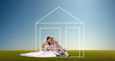 happy bride and groom - newly married couples sit on lown and dream of a house. Construction; building or hypothec home loan concept clipart