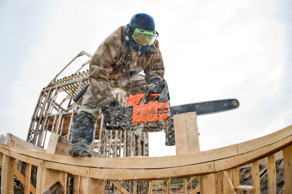 Worker with petrol-powered saw — Stock Photo, Image