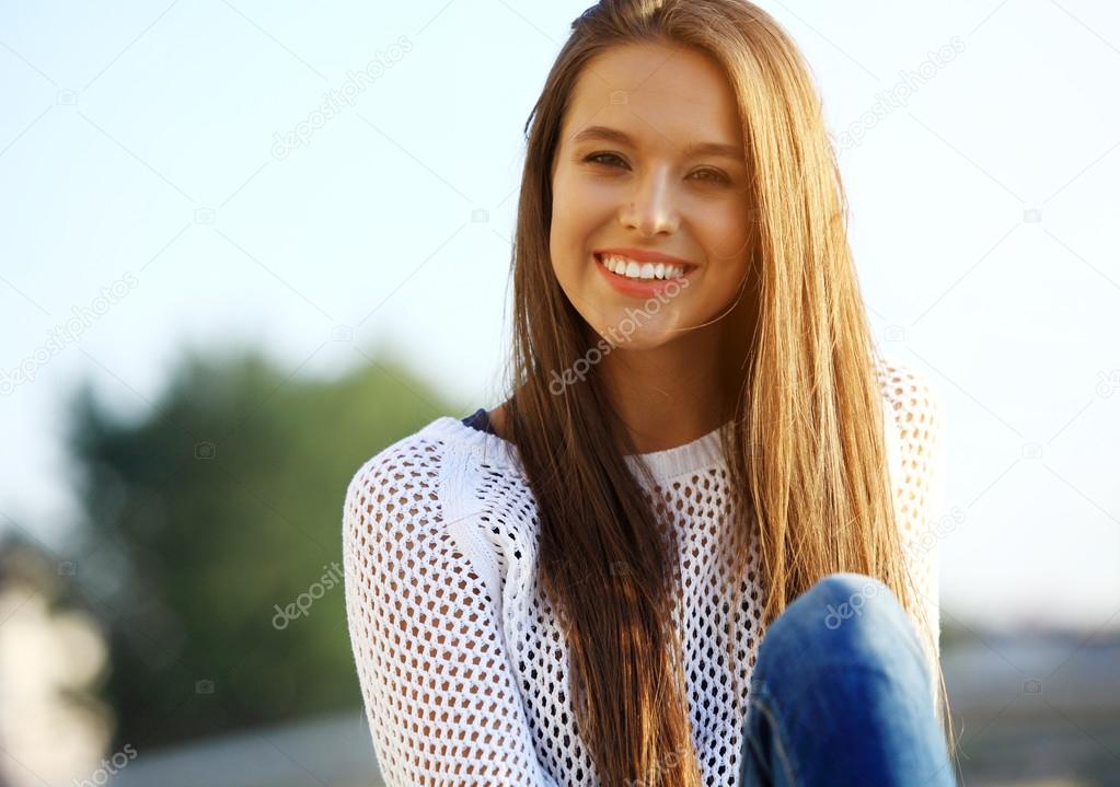 Portrait Of Young Smiling Beautiful Woman. Close-up portrait of a fresh and beautiful young fashion model posing outdoor.