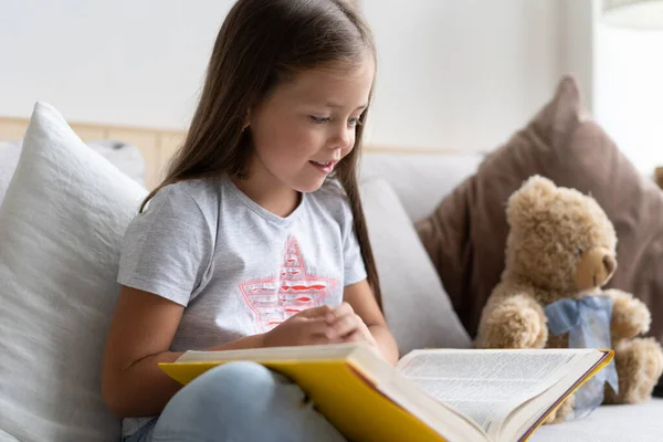 Young girl reading book at home. Distance education, home education. Self isolation concept. — Stock Photo, Image