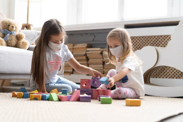 Kids children wearing mask for protect Covid-19, playing block toys in playroom. — 스톡 사진