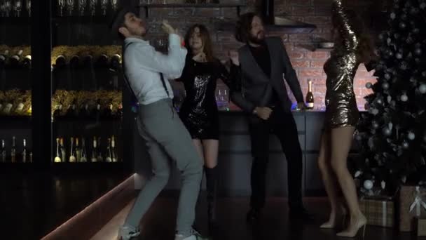 Vrienden vieren oudejaarsavond feest dansen gooien confetti genieten — Stockvideo