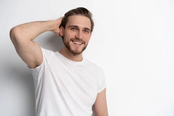 Portrait of a smart young man standing against white background. — Stock Photo, Image