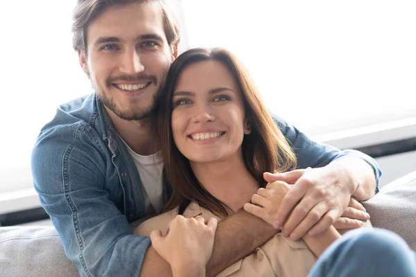 Casal feliz ou casamento abraçando e desfrutando em um sofá em casa. — Fotografia de Stock