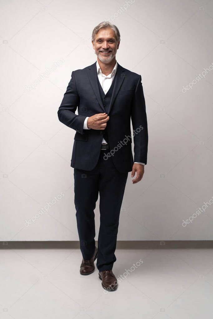 Full length shot of a mature businessman wearing a suit looking at camera