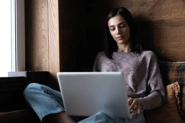 Indian mixed-race young beautiful woman using a laptop computer at home. — Stock Photo, Image