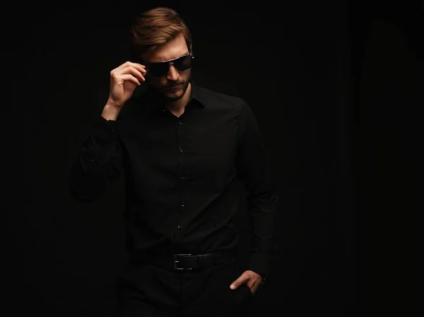 Men in full suit. Confident young businessman in sunglasses standing isolated on black. — Stock Photo, Image