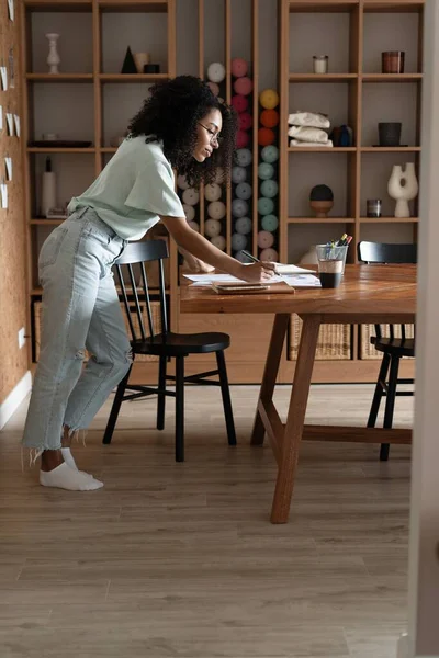 Mixte-race belle femme d'affaires travaillant avec des papiers tout en se tenant dans le bureau moderne — Photo