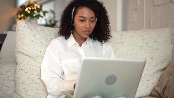 Mixed race woman using laptop typing message, chatting or working online at home — Stock Video
