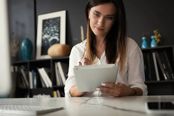 Hermosa mujer de negocios en el lugar de trabajo utilizando una tableta digital. — Foto de Stock