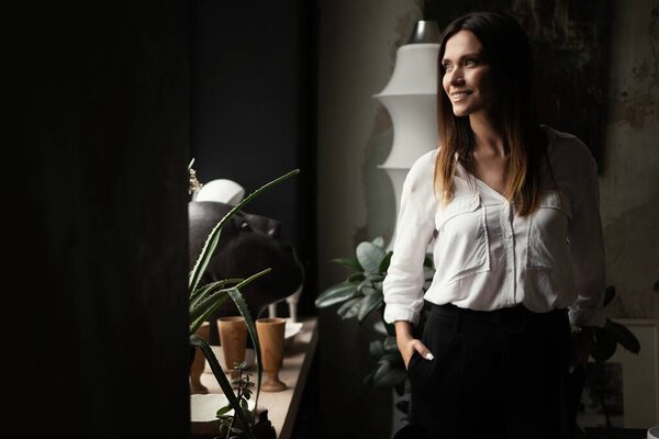 Confident stylish european middle aged woman standing at workplace, 30s lady executive leader manager in office