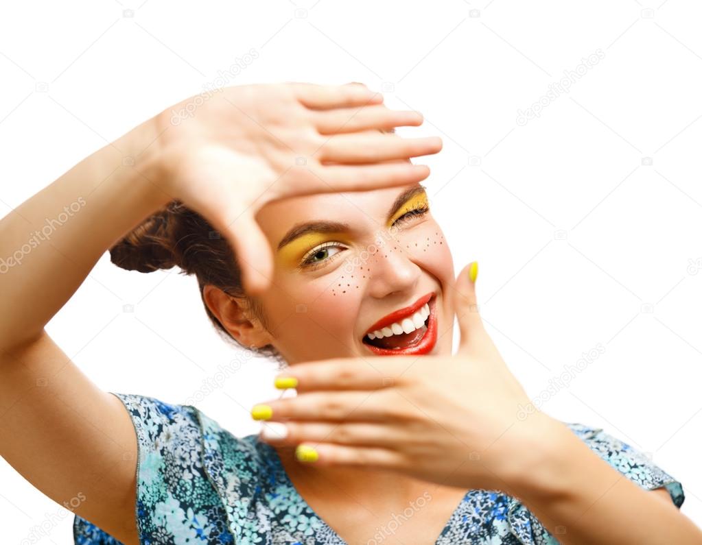 Joyful teen girl with freckles and yellow makeup