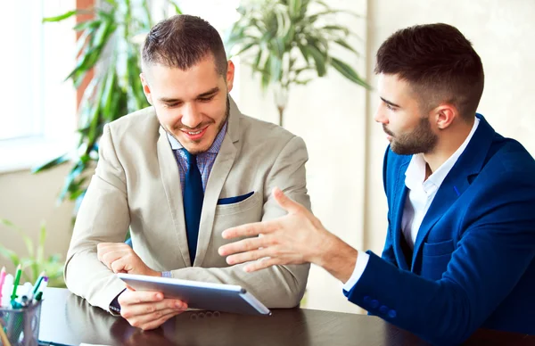 Businessmen using touchpad at meeting — Stock Photo, Image