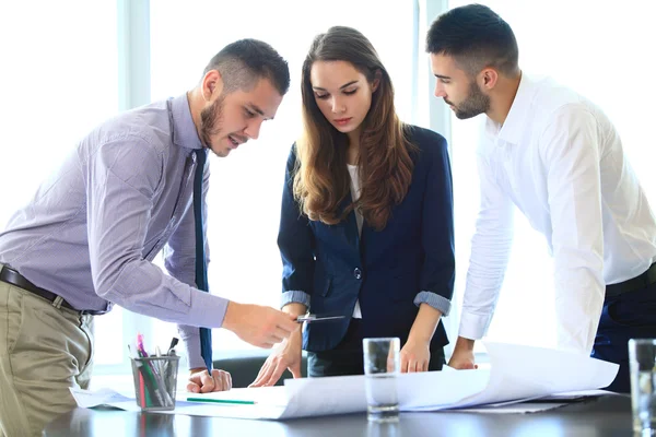 Business people working on blueprints — Stock Photo, Image