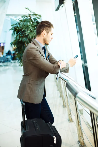 Affärsman på flygplatsen med smartphone — Stockfoto