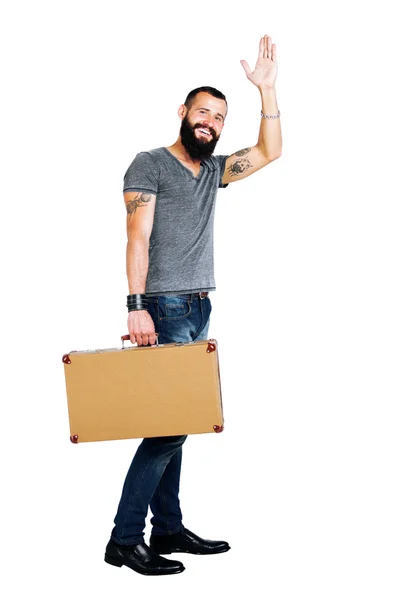 Bearded man holding a suitcase — Stock Photo, Image