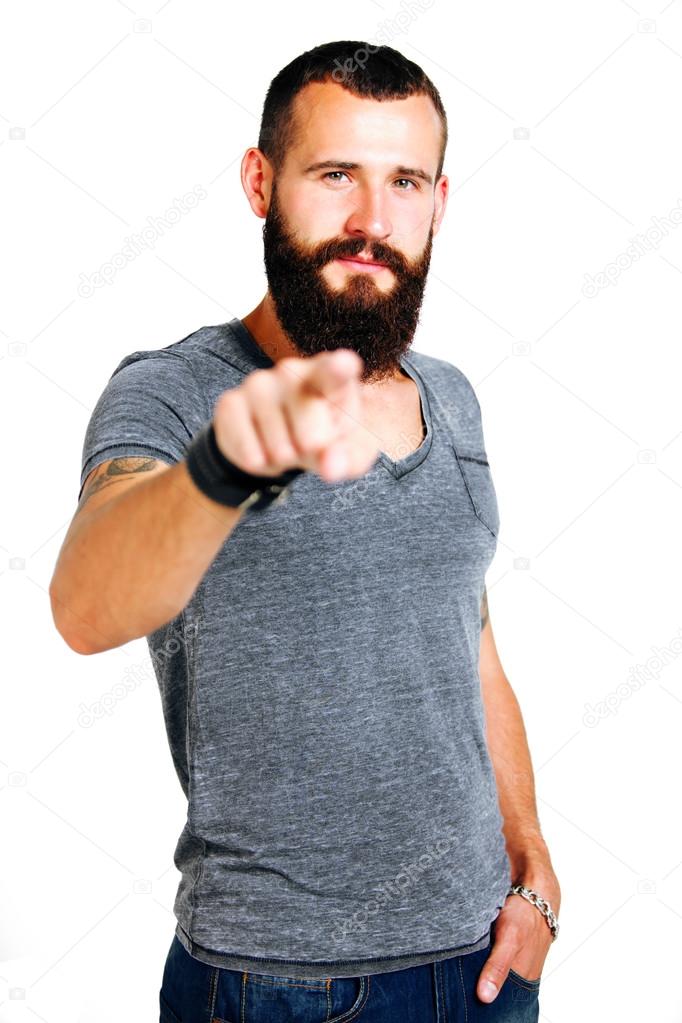 Tattooed bearded man pointing at you