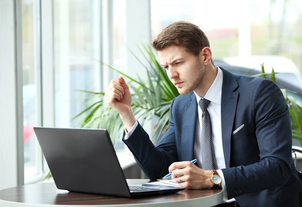 Pensive businessman in a cafe — Stock Photo, Image