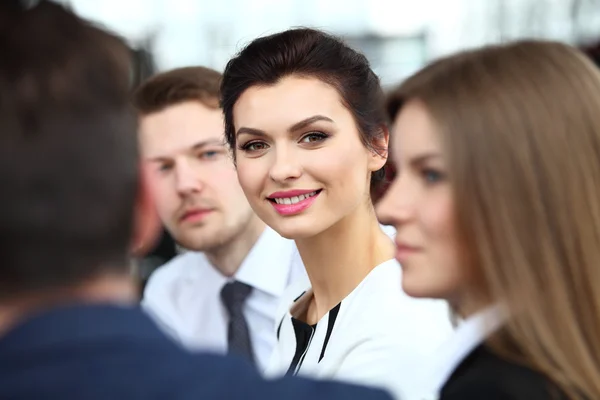 Face of beautiful woman on the background of business people — Stock Photo, Image