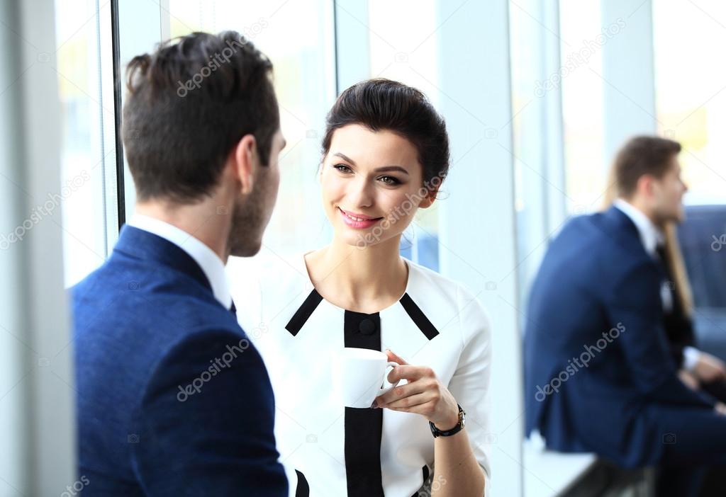 Young couple of professionals chatting during a coffee break