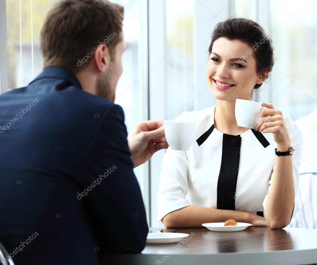 Young couple of professionals chatting during a coffee break