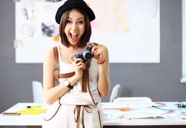 woman with camera in office