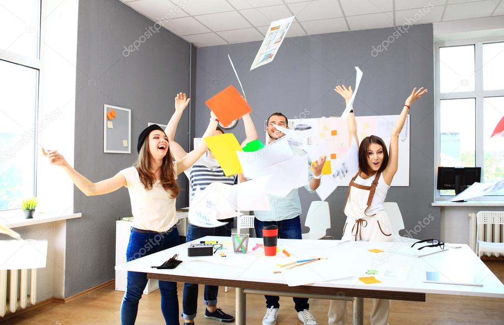 Successful business team celebrating with arms up