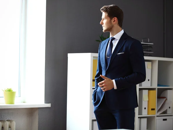 Businessman looking through window — Stock Photo, Image