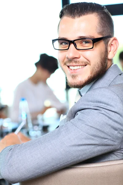 Zakenman met collega's op de achtergrond — Stockfoto