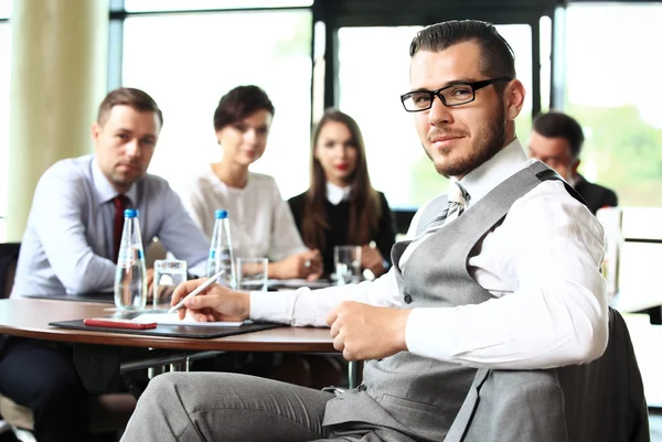 Businessman with colleagues in office — Stock Photo, Image