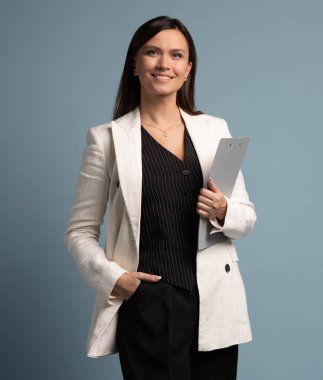 Dosyaları tutan orta yaşlı mutlu bir iş kadını. Kendine güvenen kadın kameraya bakıyor, boşluğu maviye kopyala