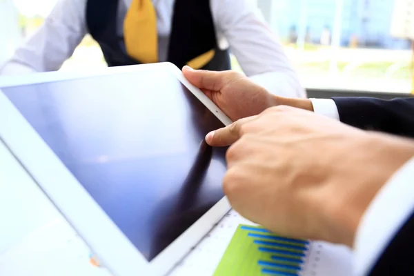 Business person analyzing financial statistics displayed on the tablet screen — Stock Photo, Image