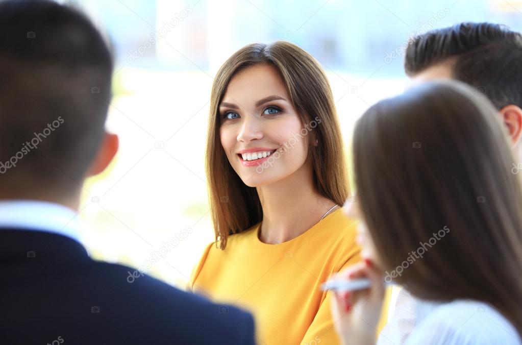 Smiling businesswoman with colleagues