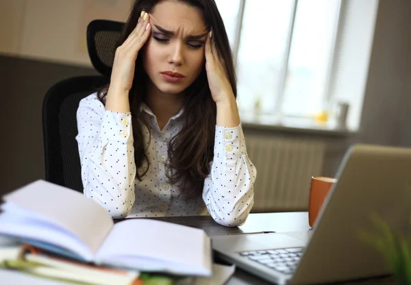 Indoor picture of bored and tired woman taking notes — Stock Photo, Image