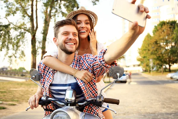 Happy couple on scooter — Stock Photo, Image