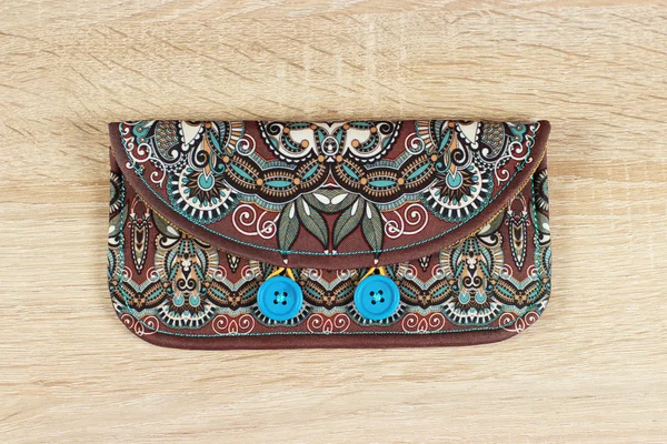 female purse money artists design with two wooden buttons