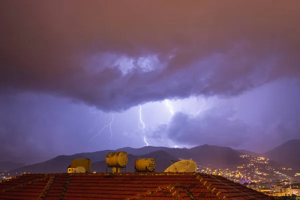 Starkes Gewitter über nächtlichen Bergen und Städten. Große helle Blitze aus nächster Nähe. Mittelmeerwinternachtgewitter. Alanya, Türkei — Stockfoto