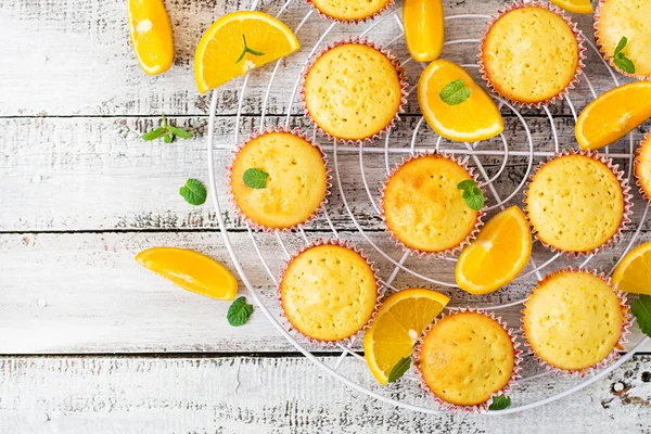 Tasty muffins with oranges and mint. — Stock Photo, Image