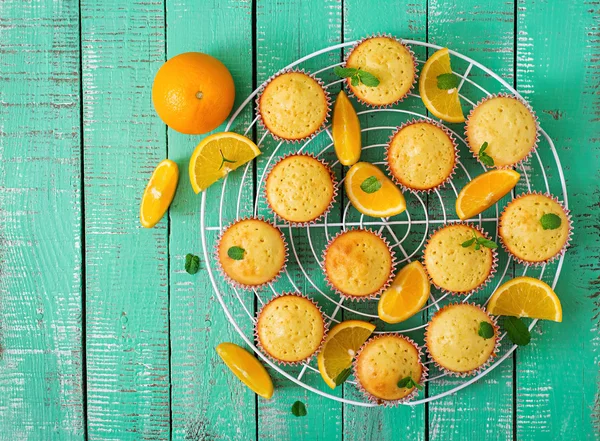 Tasty muffins with oranges and mint. — Stock Photo, Image